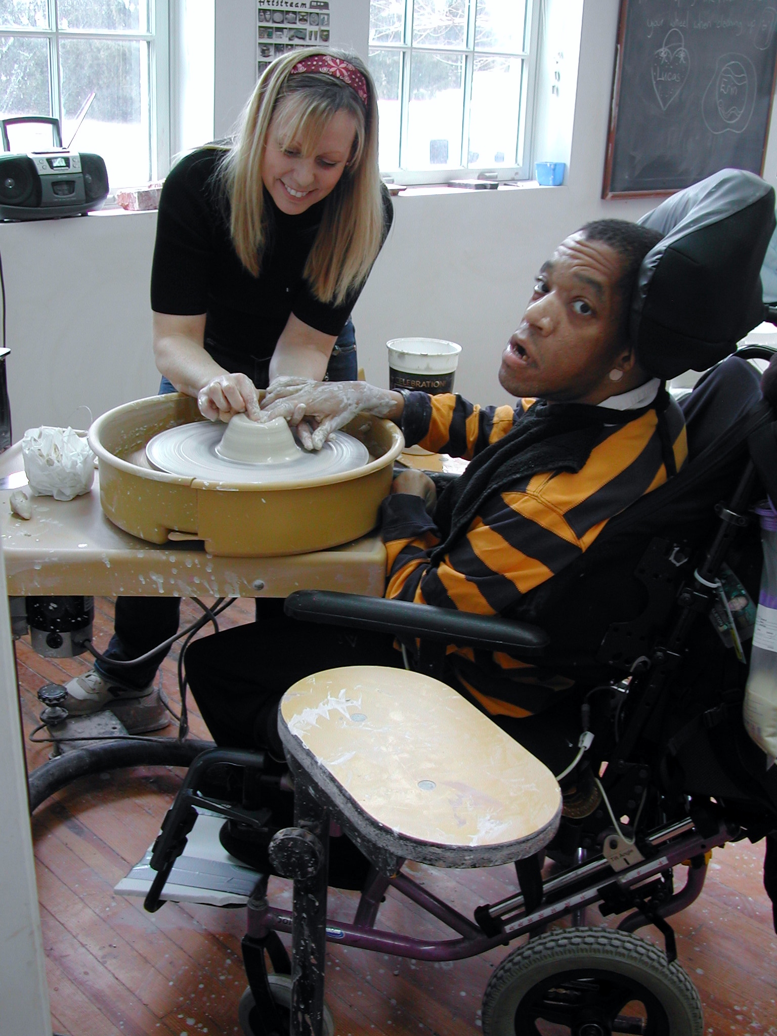 Jodi Bonthron from Matheny Ceramics works with Dion on the wheel